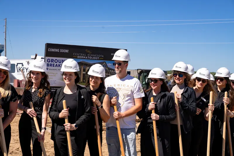 Central MN Dermatology staff in hard hats at the groundbreaking