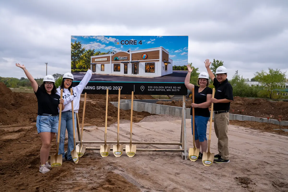 Celebrating in front of the Core 4 sign at the groundbreaking