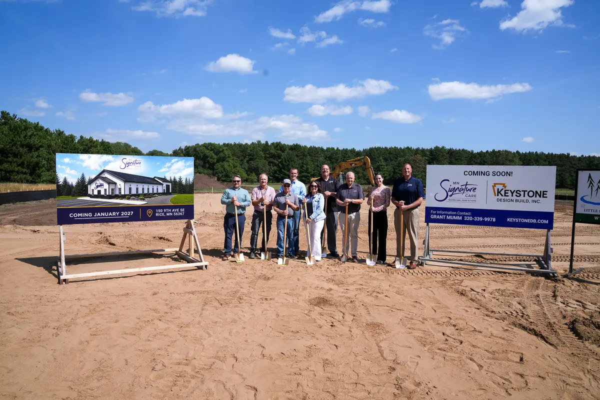 MN Signature Care groundbreaking group at the project sign in Rice