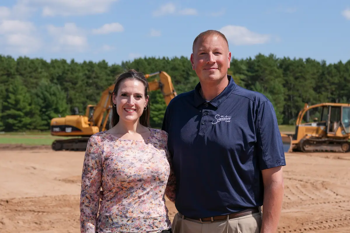 Guests on the MN Signature Care site with equipment behind them